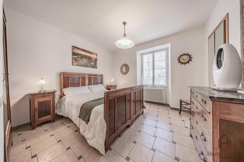 a bedroom with a bed and a dresser and a television at Behind the Sea - Parcheggio gratis - mare 5 min in Noli