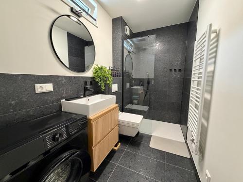 a bathroom with a sink and a toilet and a mirror at Boutique Apartment mit Balkon, Küche, Zentral, HDZ, BALI THERME, GOP in Bad Oeynhausen