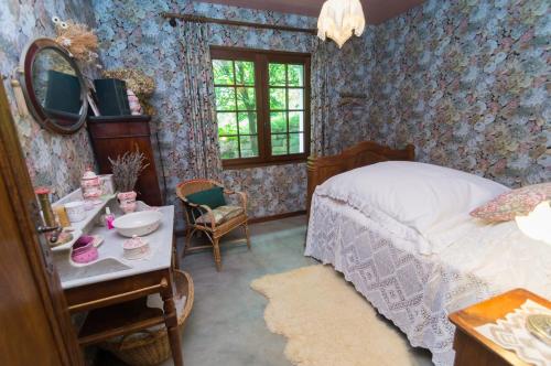 a bedroom with a bed and a table with a mirror at Gite de Loche in Quet-en-Beaumont