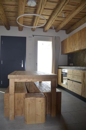 a kitchen with a wooden table in a room at BROCHETA GUEST HOUSE in Belluno