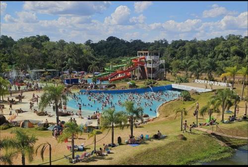 a large pool at a water park with people in it at Encantos del Monte in Gobernador Roca