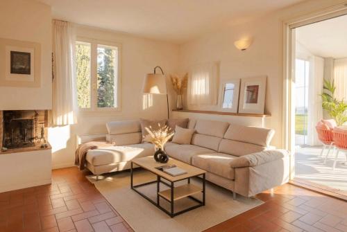 a living room with a couch and a table at VILLA OXA 12&2, Emma Villas in Imola
