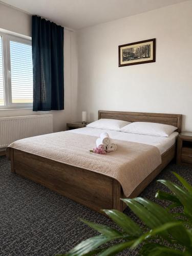 a bedroom with a bed with a teddy bear on it at Penzión Aurora Patince in Patince