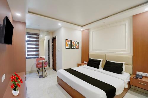a hotel room with a bed and a television at Hotel O by OYO S R Galaxy in Kānpur