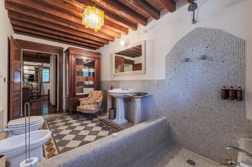 a bathroom with a tub and a toilet and a sink at VM Boutique in Castiglione di Ravenna