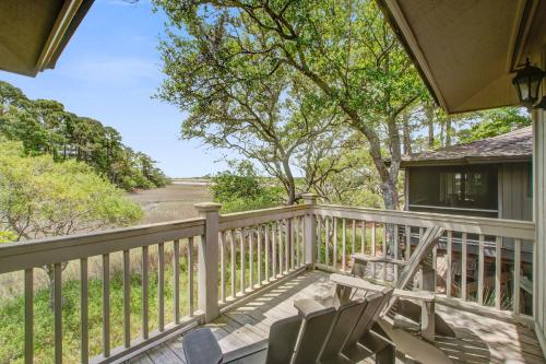 a porch with chairs and a view of a road at Inlet Cove 94 in Kiawah Island