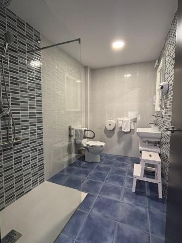 a bathroom with a toilet and a sink and a shower at HOSTAL CASA JULIO - Auto Check-in in Culleredo