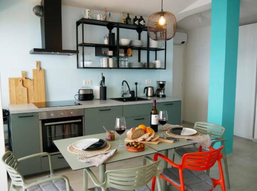 a kitchen with a table with food and wine glasses at holiday by the sea in Marusici 