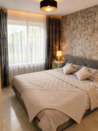 a bedroom with a large bed and a window at Villa Schönfeld in Schönfeld