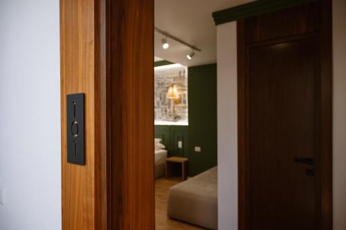 a door leading to a bedroom with a bed in a room at Tomas Inn in Pogradec