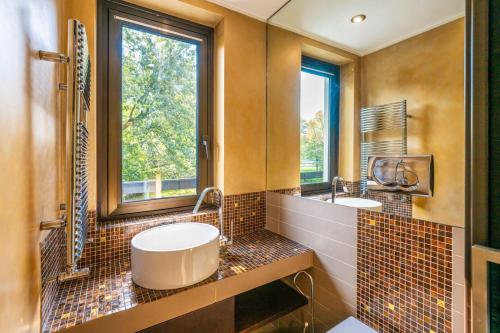 a bathroom with two sinks and a window at Villa San Siro Olympic Stadium in Milan
