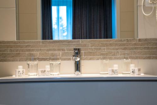 a bathroom sink with a faucet and a mirror at Hotel - Restaurant Valley Rose in Vienna