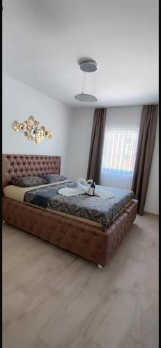 a large bed sitting in a room with avertisementatronatron at Emma Lux Apartment in Dobra Voda