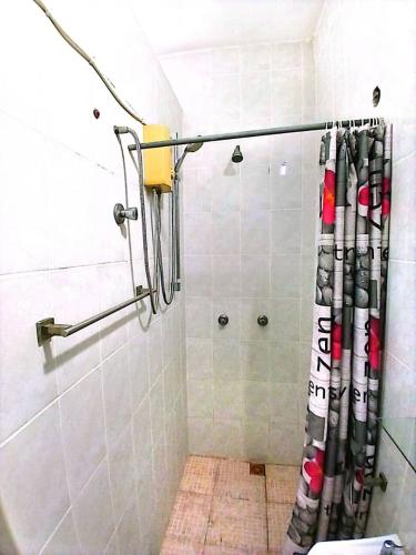 a shower with a shower curtain in a bathroom at Vesper Apt-Osu in Christiansborg
