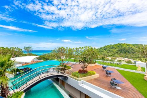 an aerial view of a bridge over a swimming pool in a resort at Crest Resort & Pool Villas in Patong Beach