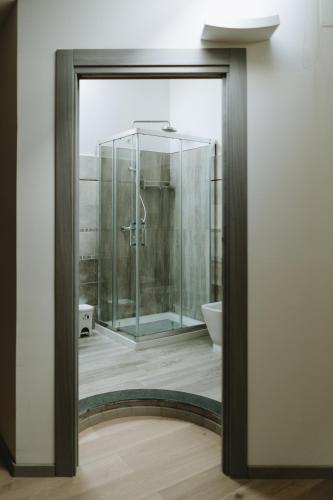 a bathroom with a glass shower and a toilet at Aura Residence in San Biagio