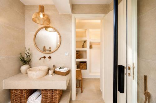 a bathroom with a sink and a mirror at Villa Pelagos in Koutsounari