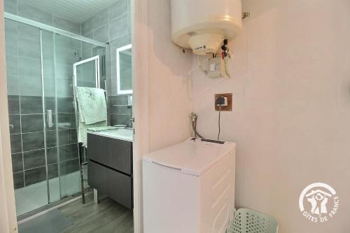 a bathroom with a toilet and a sink and a shower at Ty amzer'zo in Ploulech