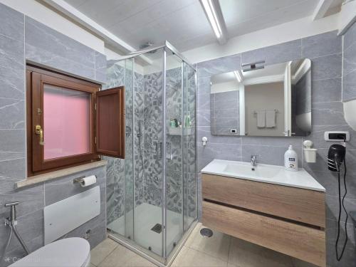 a bathroom with a shower and a sink and a toilet at Il Silenzio del Mare in Gaeta