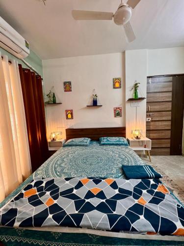 a bedroom with a bed with a checkered blanket at Sugar Waves in Navi Mumbai