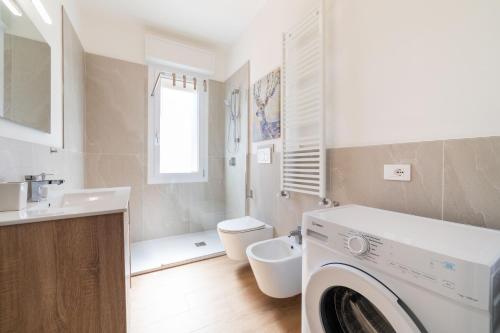 a white bathroom with a washing machine in it at Casa MaMi in Gatteo a Mare