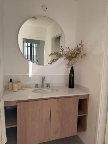 a bathroom with a sink and a mirror at Moras Urban in Esperanza