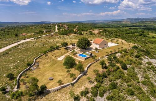 an aerial view of a house with a swimming pool at Potkova in Lađevci