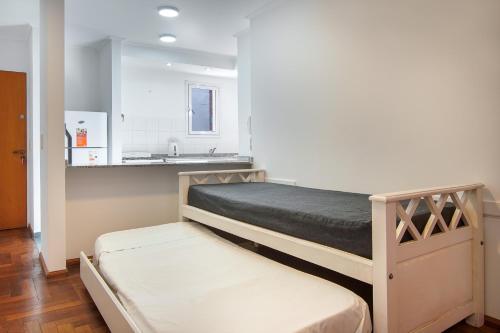a bedroom with a bed and a sink in it at Lofty Departamentos Temporarios in Córdoba