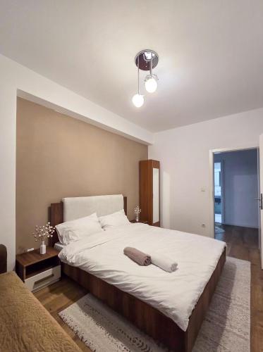 a bedroom with a large bed with a pillow on it at White Ribbon Prizren in Prizren