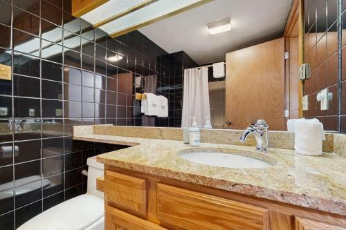 a bathroom with a sink and a toilet and a tub at Christmas Mountain Retreat in Bartlett
