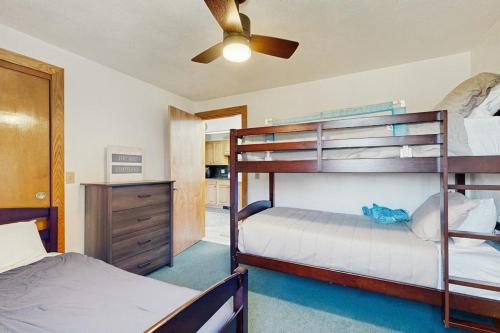 a bedroom with two bunk beds and a ceiling fan at Christmas Mountain Retreat in Bartlett