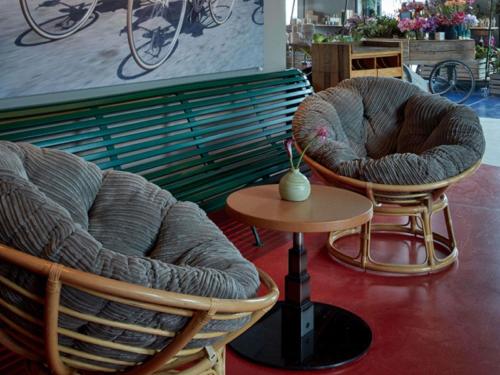 two chairs and a table next to a bench at 25hours Hotel Das Tour in Düsseldorf