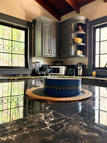 a kitchen with black cabinets and a blue cake on a counter at Hostal Marias in Copán Ruinas