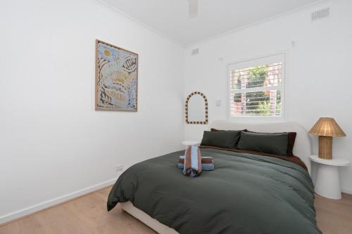 a bedroom with a bed and a window at Oak and Olive - Glenelg in Glenelg