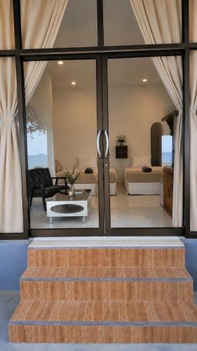 a staircase leading to a living room with a couch at Nami by Secret Place in Mae Haad