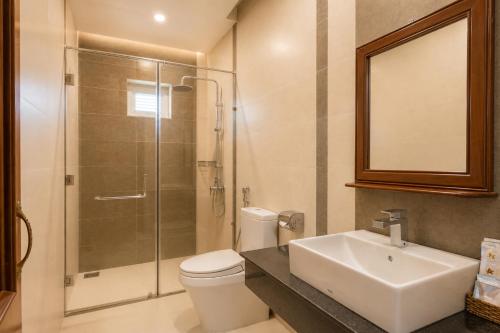 a bathroom with a toilet and a sink and a shower at Casa de LYN Nha Trang in Nha Trang