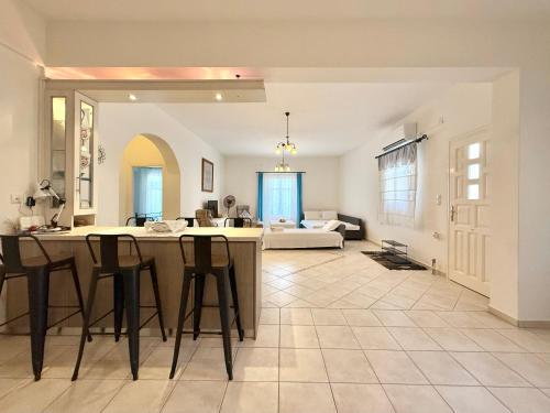 a kitchen and living room with a table and chairs at Villa Fenia in Aegiali