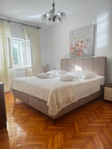 a bedroom with a large bed in a room at Sunset Hill Apartments in Brodarica