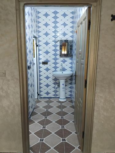 a bathroom with a sink and a white sink at Gîte d'étape Imane Café ET Restaurant in Aït Amar