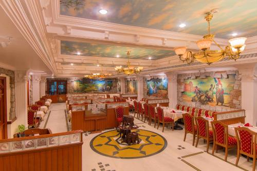 a restaurant with tables and chairs in a room at Hotel Annamalai International in Puducherry