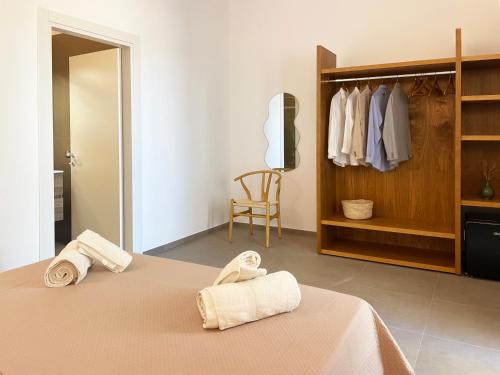 a bedroom with a bed with towels on it at Dimora Thalèa - Retreat & Rooms in Nardò