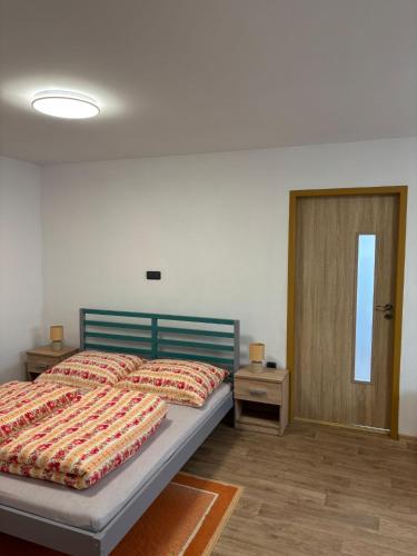 a bedroom with a bed and a door with a window at Chalupa u dědy in Kozlov