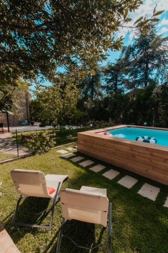 two chairs and a swimming pool in a yard at DONNA LAURA - Holiday Home in Arezzo