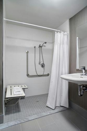 a bathroom with a shower and a sink at Courtyard by Marriott Toronto Downtown in Toronto