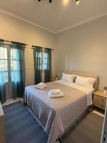 a bedroom with a bed with two towels on it at Anassa Homes Leros in Agia Marina