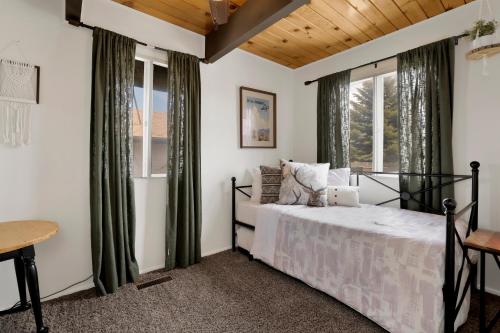 a bedroom with a bed and a window at Big Bear Bungalow #643 in Big Bear City