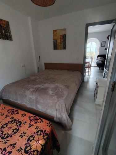 a bedroom with a large bed and a table at Reka Casa in Mojácar