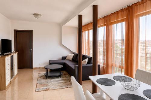a living room with a couch and a table at Family Hotel Kosko in Chernomorets
