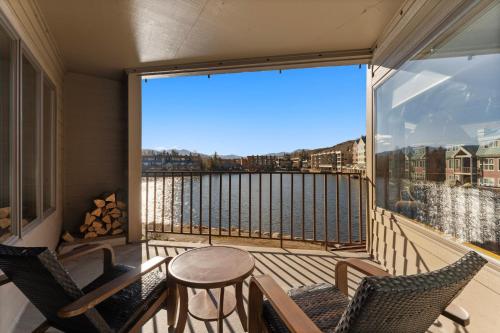 a balcony with chairs and a table and a large window at Willows #1713 in Keystone