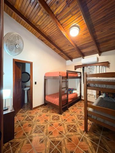 a room with two bunk beds and a ceiling at Hostal Marias in Copán Ruinas